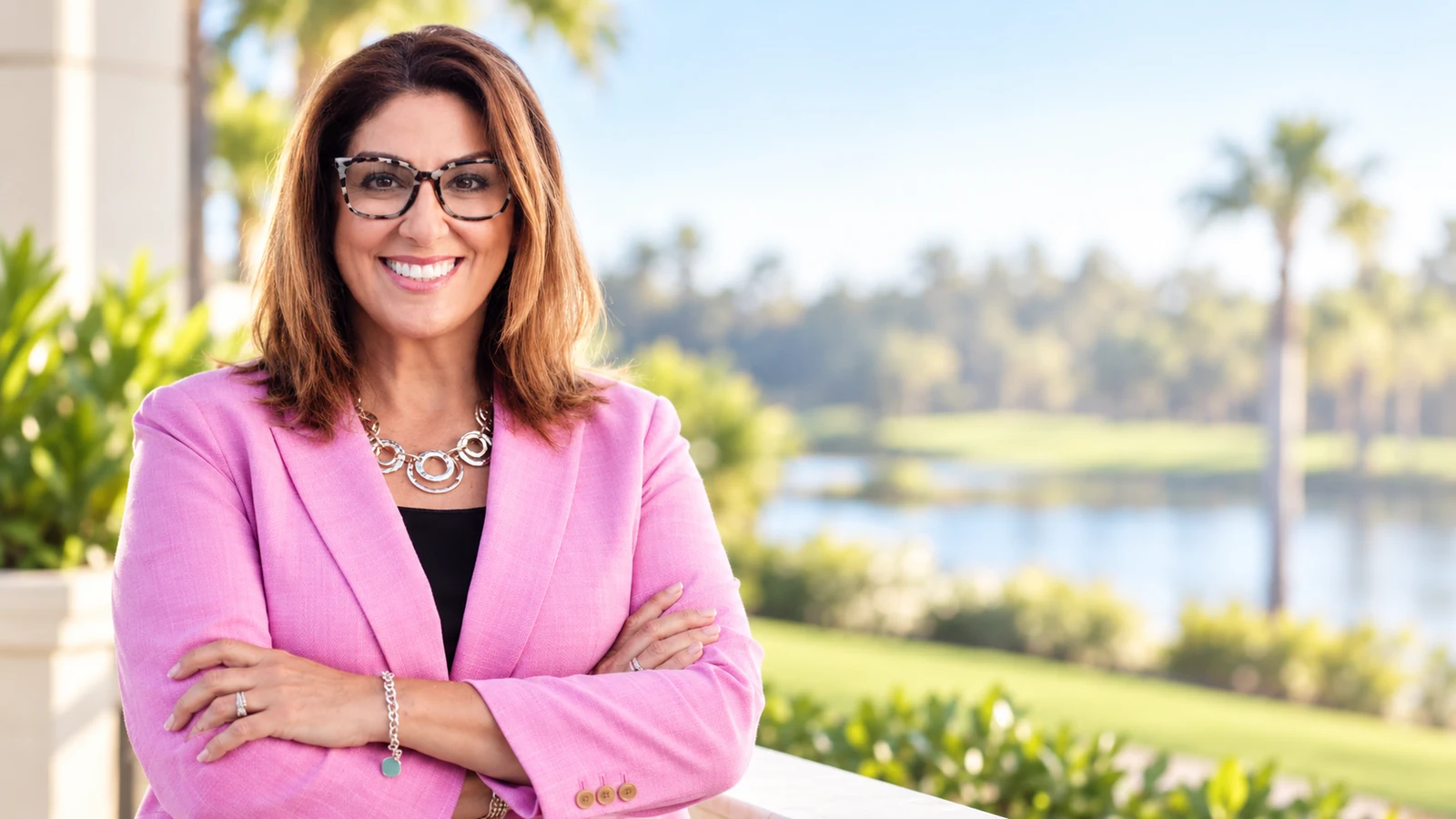Ilona Fischer in a pink blazer, executive portrait outdoors